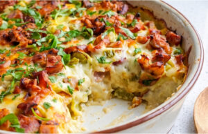 Baked Potatoes with Sausage: Hearty Dinner or Lunch with Mozzarella and Delicate Egg Sauce Baked potatoes with sausage, mozzarella and creamy egg sauce in a baking dish