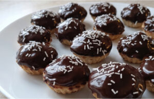 Cups Inspired by Drunken Isidor: Nut Filling, Cocoa Cream, and Chocolate Glaze Cups inspired by Drunken Isidor with nut filling, cocoa cream, and chocolate glaze