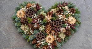 Fir, Cone and Flower Hearts: 20 Beautiful All Souls’ Day Decorations You Can Make at Home Richly decorated natural heart with fir, cones, and flowers
