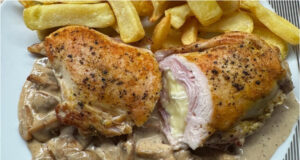 Chicken Pocket with Ham and Brie: Juicy Meat on a Creamy Mushroom Bed Juicy chicken pocket stuffed with ham and Brie cheese on a creamy mushroom bed with steak fries