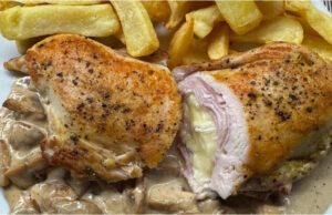 Chicken Pocket with Ham and Brie: Juicy Meat on a Creamy Mushroom Bed Juicy chicken pocket stuffed with ham and Brie cheese on a creamy mushroom bed with steak fries