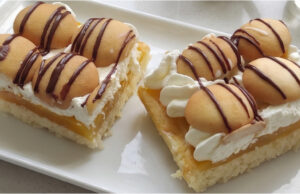 Viennese Dessert with Orange Pudding: Moist Layers with Mascarpone and Rum-Soaked Ladyfingers Luxury Viennese layered dessert with orange pudding and mascarpone