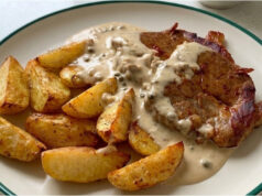 Pork Neck Steak with Pepper Sauce: Juicy Meat and Golden Roasted Potatoes Pork neck steak with pepper sauce, juicy meat and golden roasted potatoes
