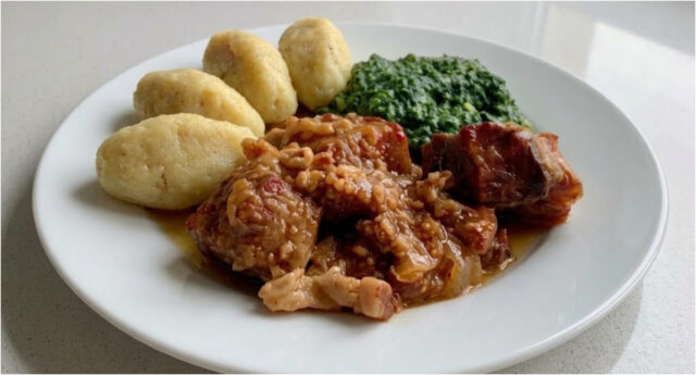 pork-roast-dumplings-spinach Golden roasted pork belly with potato dumplings and creamy spinach on a plate