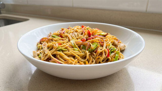 quick-chicken-noodles-variation-348 Quick chicken noodles with colorful vegetables and glossy sauce in a bowl