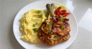 Reverse Pork Neck Schnitzels: Juicy Meat Baked with Onions and Bacon Reverse pork neck schnitzels baked with onion and bacon
