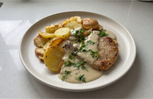 Quick Pork Chops with Parmesan Sauce: Juicy Meat Thanks to Baking Under Foil Juicy pork chops with creamy Parmesan sauce served with mashed potatoes
